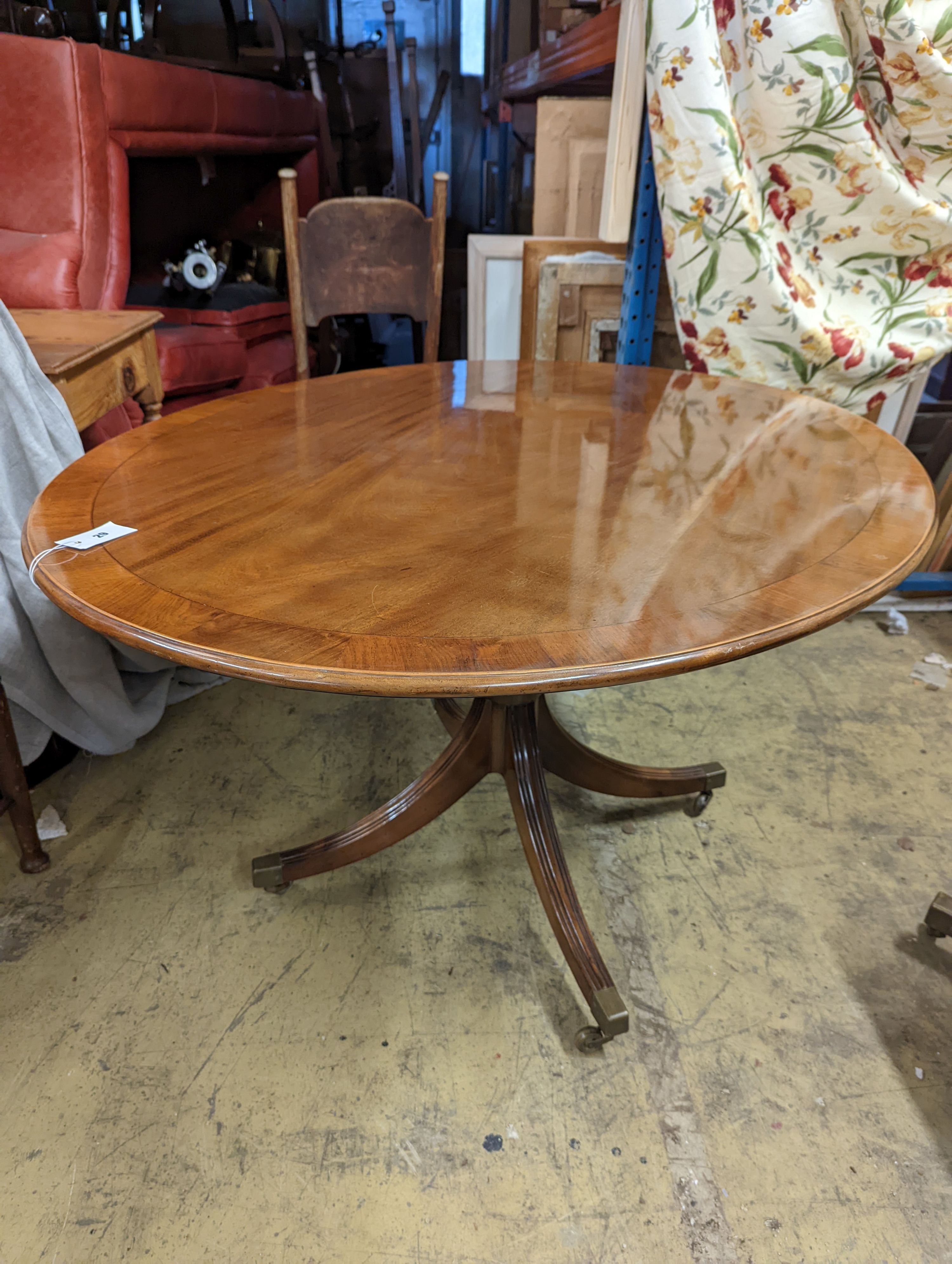 Attributed to William Tillman. A reproduction George III style oval mahogany pedestal tilt top dining table, width 105cm, length 135cm, height 72cm
